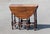 This vintage English William and Mary style gateleg table is a masterpiece of traditional craftsmanship, featuring a rich...