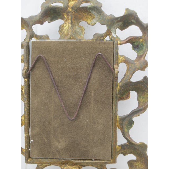 Ornate cast brass frame in the favorite Victorian style, Rococo. Closes with a pressure clasp on the back, holding it...