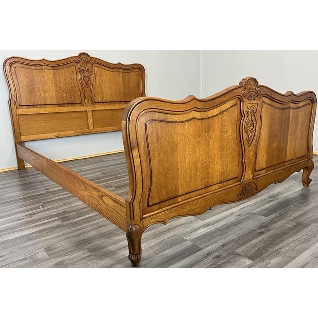 A beautiful Vintage French Louis double bed frame , featuring elegant carved detailing, a warm oak finish, and sweeping...