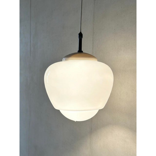 1960s acorn shaped opaline pendant lights by czech light makers napako. napako is a historical czech lighting manufacturer...