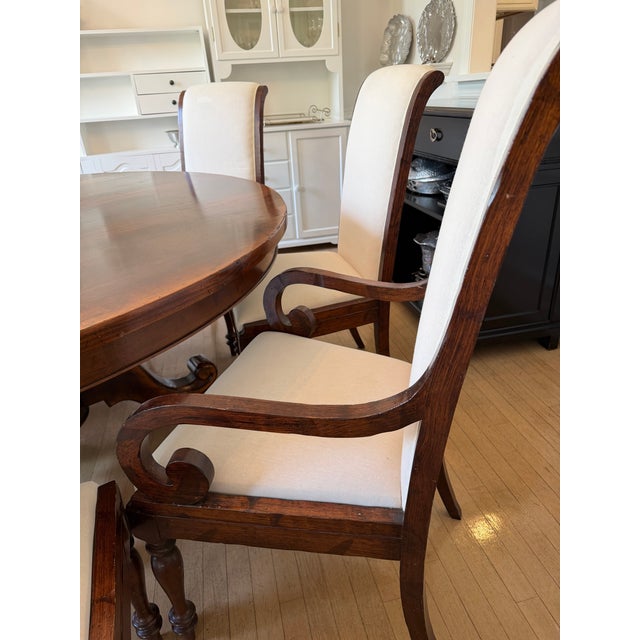 A stunning round dining table, with a heavy center pedestal for the perfect dining and conversation experience- everyone...
