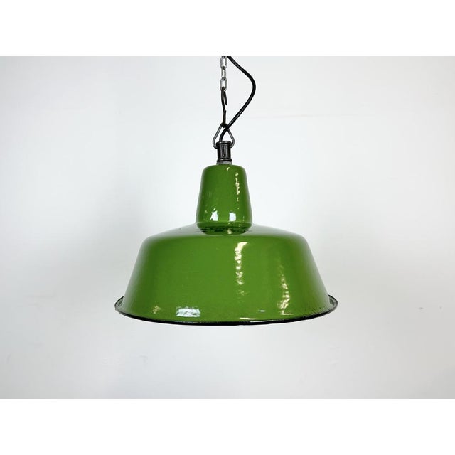 Industrial green enamel pendant light made by Zaos in Poland during the 1960s. White enamel inside the shade. Cast iron...