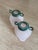 A set of two glass bud vases with verdigris metal caps. These 1980s pieces are designed to be displayed as a set; they...