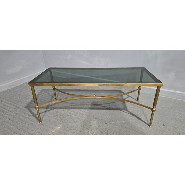 A very good French coffee table in the Jansen Maison style, brass stand with smoked glass top, in very good original...