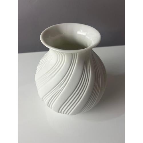 This vase, crafted from the finest bisque porcelain, is a collector's item resulting from the collaboration between...