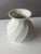 This vase, crafted from the finest bisque porcelain, is a collector's item resulting from the collaboration between...