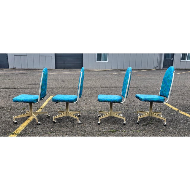 Absolutely beautiful vintage dining room chairs in a turquoise and dark blue with a gold base on casters! It doesn't get...