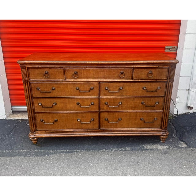 British West Indies styling From the "Bali Hai" collection, nine-drawer dresser in maple and cherry in a warm chestnut...