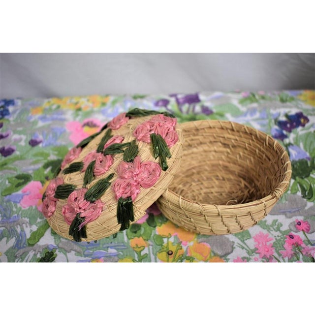 Fabulous vintage raffia basket. Lidded and featuring a floral design on top. Perfect for Easter and spring. Could store...