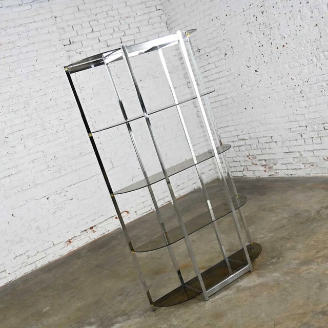 Gorgeous mid-century modern etagere comprised of a bow shape chrome frame and 5 bowed smoked glass shelves. Done in the...