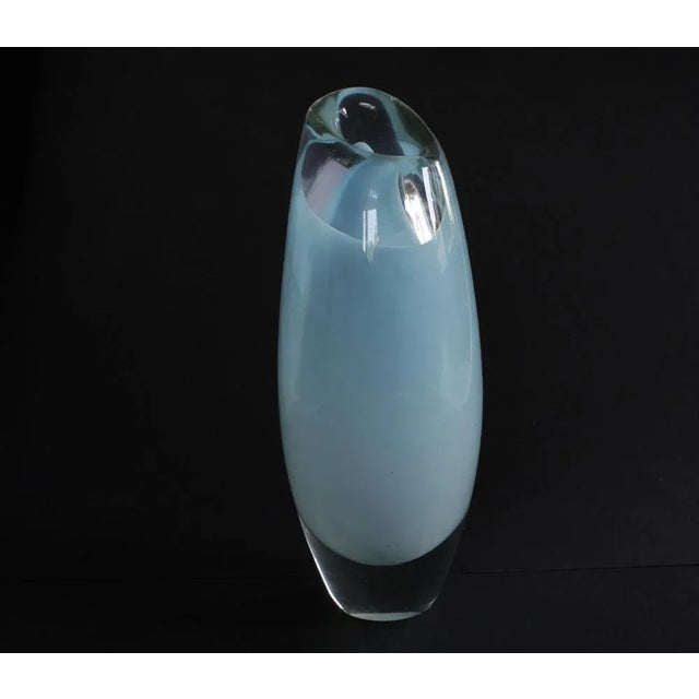 A beautiful light blue heavy vase made by Vicke Lindstrand. 24cm high and 11cm wide This piece is designed in the style of...