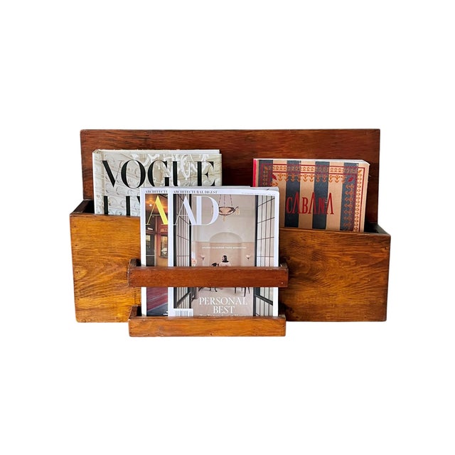 A striking vintage solid wood storage piece featuring clean architectural lines and a warm, richly grained wood finish....