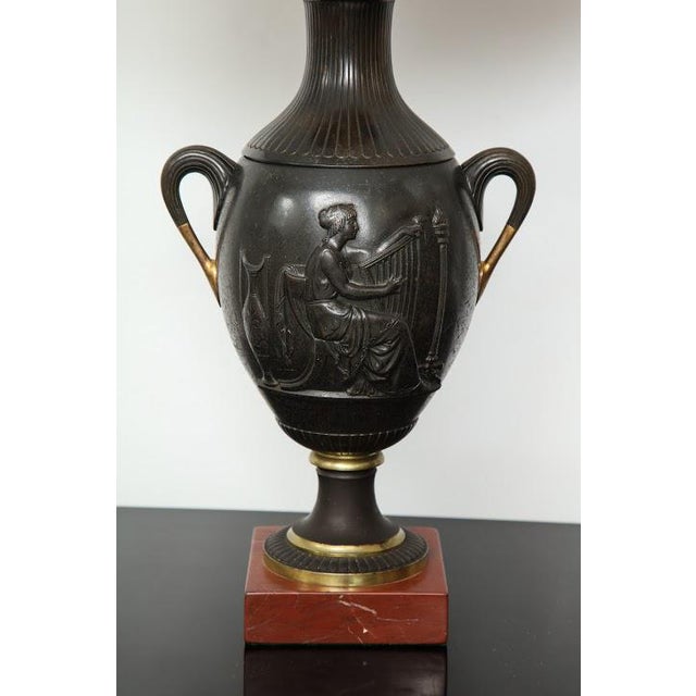 Pair of antique French bronze urn lamps in the neoclassic manner.