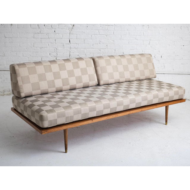 Wood-framed mid-century daybed, styled after George Nelson. Newly reupholstered in checker-pattern silk fabric.