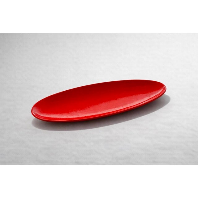 Important red glazed earthenware shuttle-shaped bowl by Pol Chambost, France, circa 1950. Signed "Pol Chambost pottery...