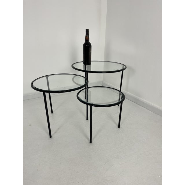 Set of 3 low swivel tables, made in Italy, 1980s Enamelled metal wire frame and glass tops. Good condition.