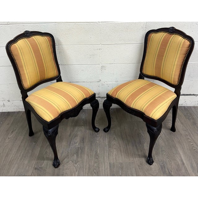 This is an elegant pair of vintage, possibly antique, French Louis XV Revival side chairs featuring shaped backs, carved...