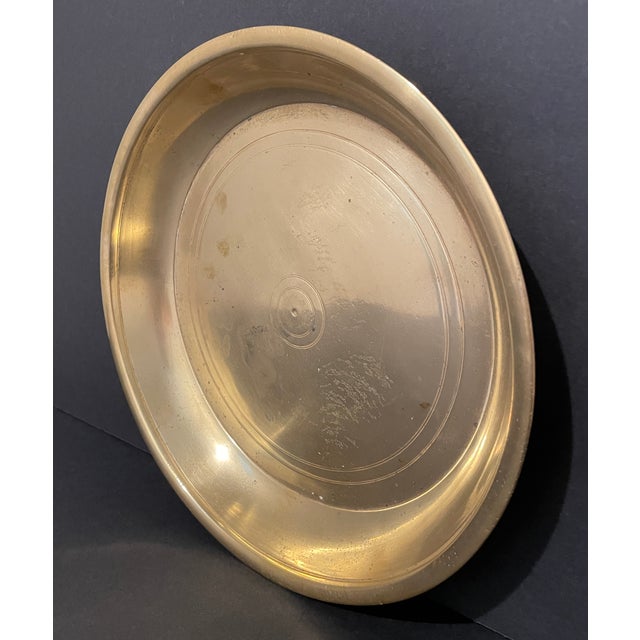 Heavy antique brass round tray or charger, heavy at 2.5 pounds and 10.5 inches in diameter. This works as tray for your...