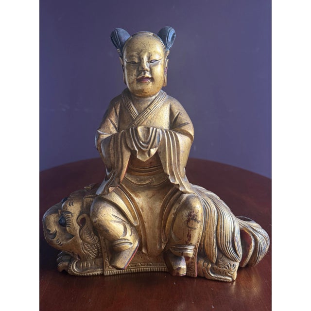 Wonderful Chinese carved wooden Quan Yin or Ancestor figurine sitting atop a foo dog. Very Zen and peaceful. There is a...