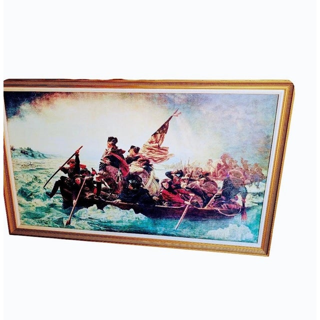 This is a framed art print of Emanuel Leutze's 1891 painting, Washington Crossing the Delaware. This iconic image depicts...