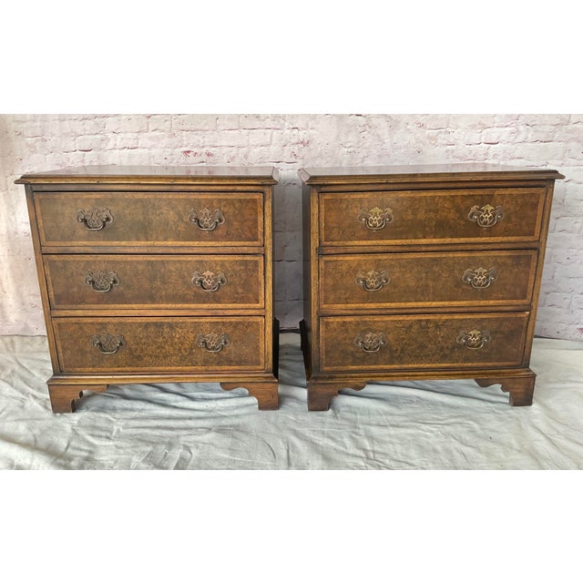 Pair of Georgian Style Burl Wood Side Chests. These chests are executed in figured burl wood veneers with contrasting...