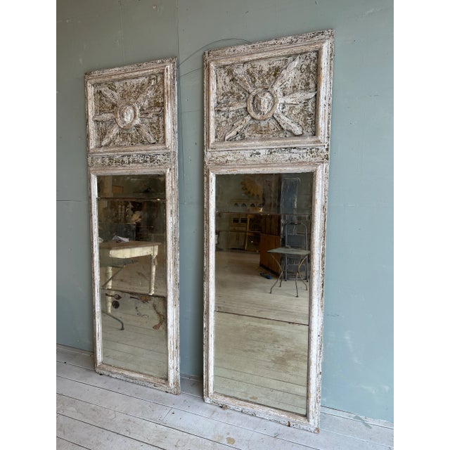 Beautiful pair of Italian Tuscan mirrors, featuring handpainted patina, and carved face motif. Perfect in an entryway over...