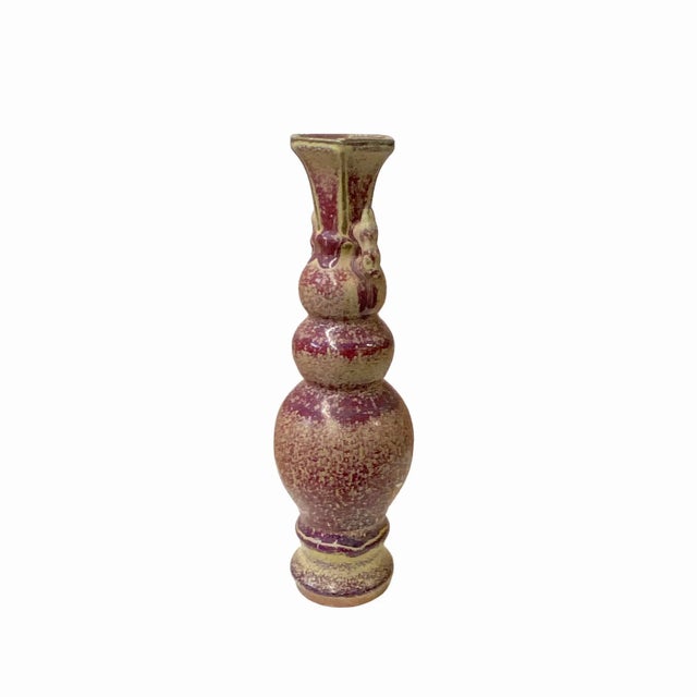 This is a handmade decorative ceramic vase in a distressed plum purple #713443 tan marks mix color finish. It has a narrow...