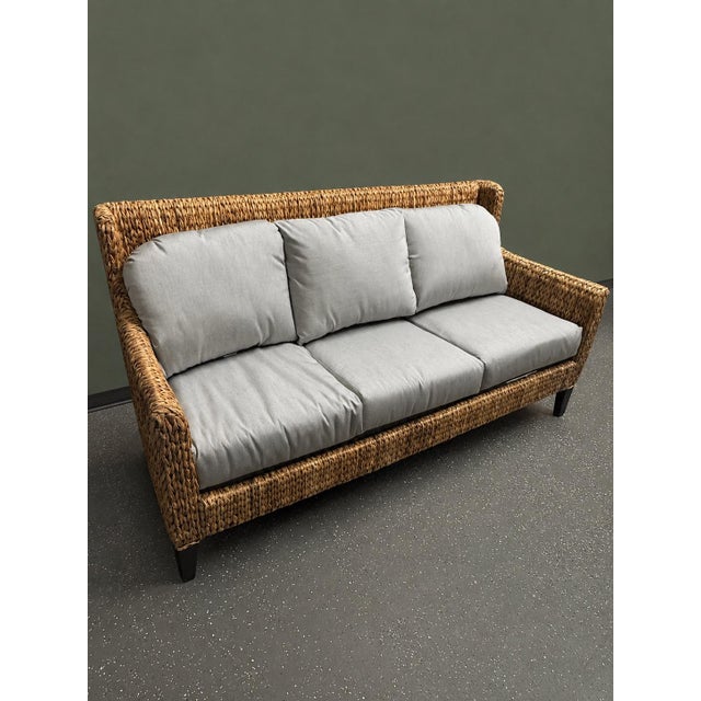 A beautifully crafted sofa from Baker Furniture's Milling Road collection. It features a substantial, woven seagrass frame...