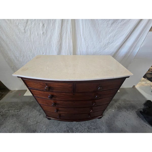 This refined early-20th-century English bowfront commode blends timeless Georgian elegance with luxurious materials....