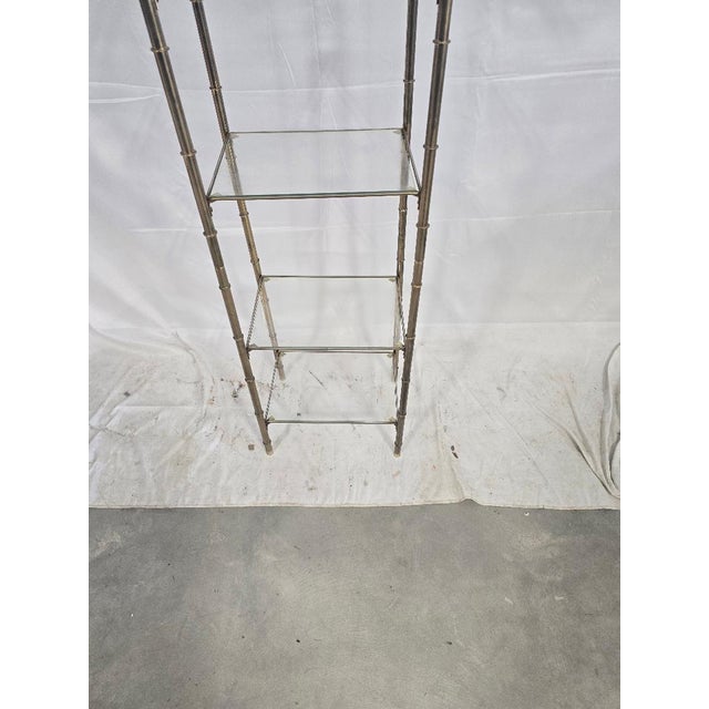 Crafted with an eye for both aesthetics and functionality, this Vintage Brass and Glass Display Shelf stands at an...