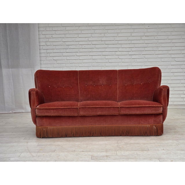1970s, 3-seater Danish curved sofa. Original pink furniture velour, brass springs in the, beech wood legs with brass...