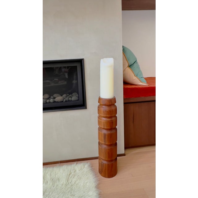 Here is a rare, large-scale candle holder in staved teak, characterized by its architectural, stacked silhouette and warm...