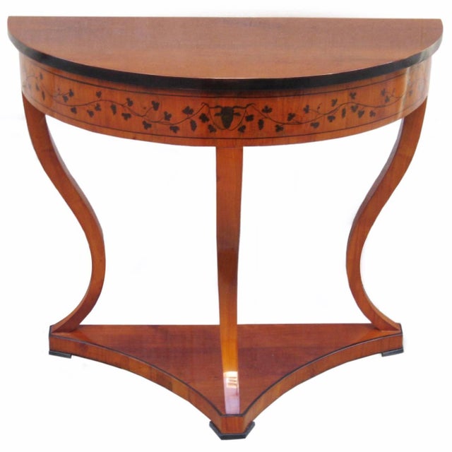 A fine Biedermeier demilune console. Cherrywood with fine pen work details and ebonized fruitwood details.