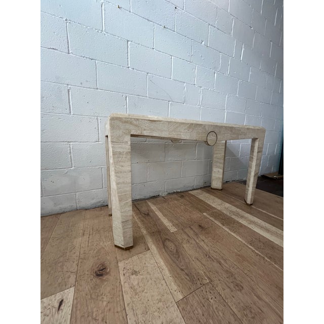 An exceptional tessellated waterfall console table accented with refined brass banding and executed in the sophisticated...