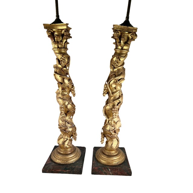 A pair of 18th century Italian Solomonic gilded columns with fruit and vines carved surround. The columns are circa 1780...