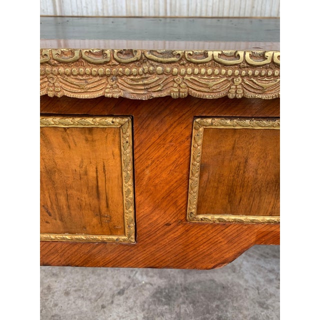 Crafted in Paris, France, circa 1870 in the style of Francois Linke and built of walnut , the large antique desk stands on...