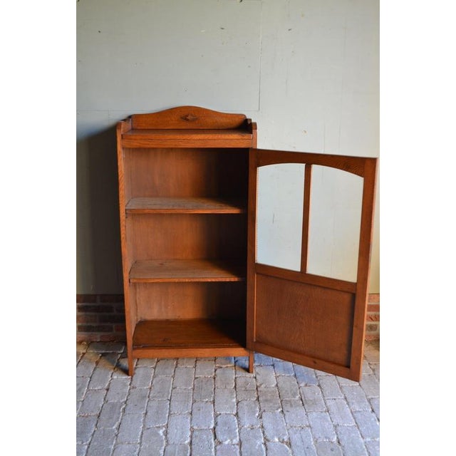 Description: 20th-century Dutch oak Art Deco display cabinet, bookcase, shop cabinet, china cabinet, or library cabinet....