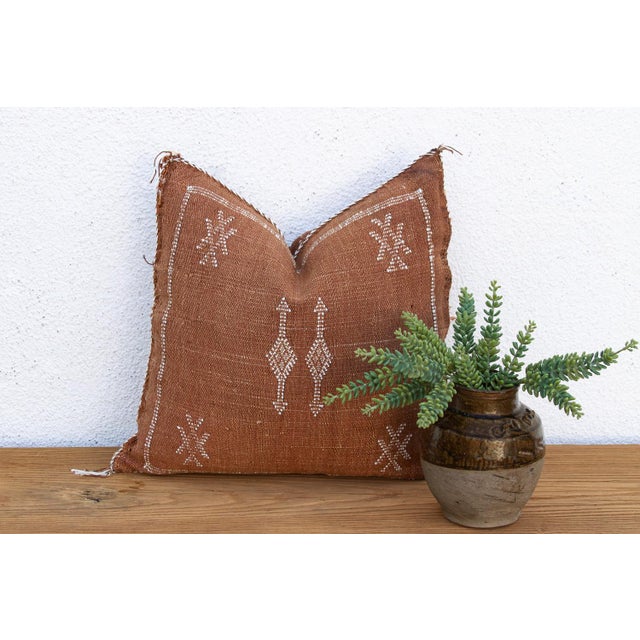 A vertical column of stacked diamonds and arrow motifs runs down the center of this handcrafted Moroccan cactus silk...