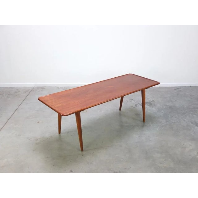 Lovely coffee table designed by Hans Wegner for Andreas Tuck in 1954. The top is made out of solid teak wood and stands...