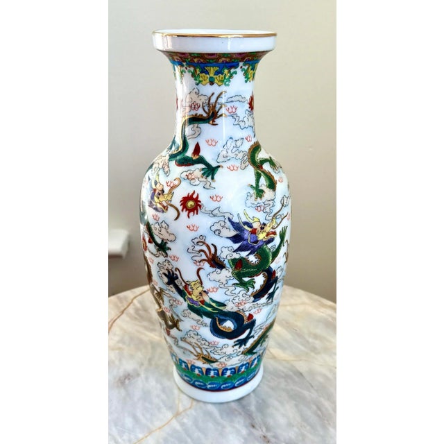 This hand-painted Chinese porcelain vase features a dramatic dragon motif wrapped in clouds and flame scrolls—rich in...