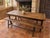 Antique French dining set comprising a large solid oak farmhouse table and two matching long benches, likely dating from...