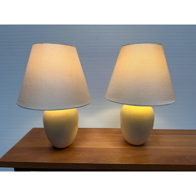 Design Plus Gallery presents a Pair of Eggshell Ceramic Table Lamps with a Ginger Jar Shape. They have contemporary...
