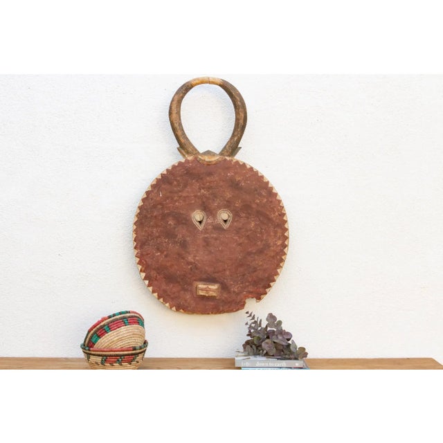 A charming African art piece, this Kple Kple mask belongs to the Goli mask group and is a symbol of fertility in...