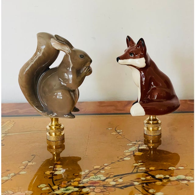 Two super cute glazed ceramics figurines of a squirrel ( Denmark) and red fox on brass bases as lamp finials.