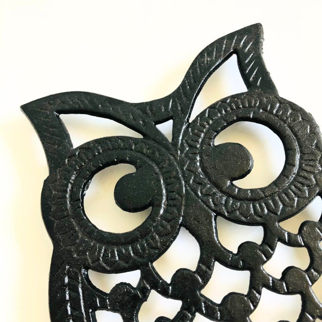 An adorable mid century cast iron trivet in the shape of an owl. Great stylized detail. Elevated on metal feet to protect...