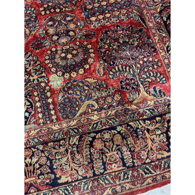 Handmade antique Muiddle Eastern rug in traditional floral design. The rug is from the beginning of 20th century in...