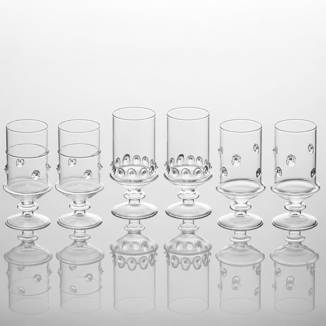 A unique set of 6 clear glass votives in three styles, two each of each design shown. Attractive with candles or as a...