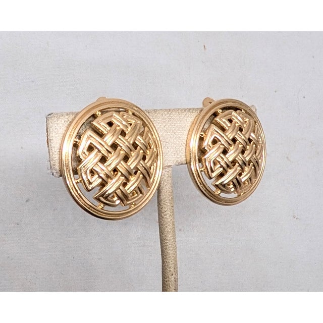 Late 1950s round domed "woven" openwork Celtic knot clip earrings. Marked crown "TRIFARI©" on the clips. Measure :1 1/8...