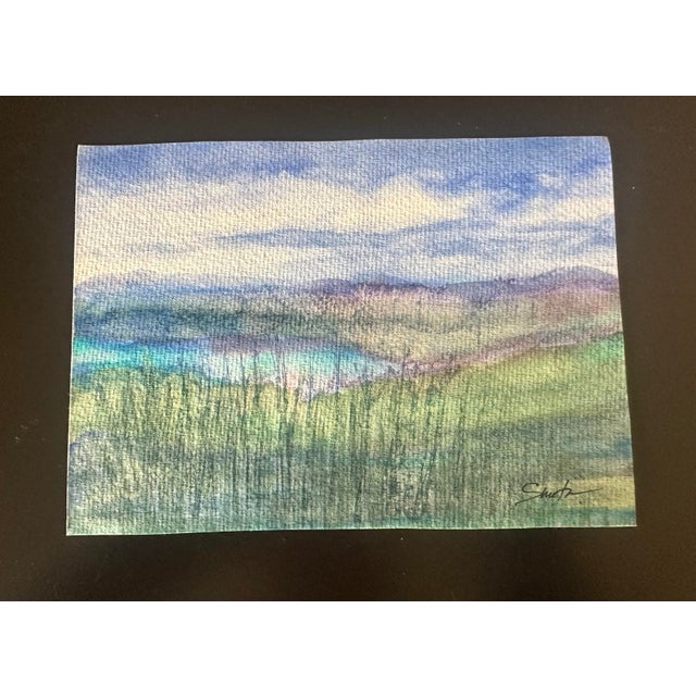 A lake nestled beyond the weeds.