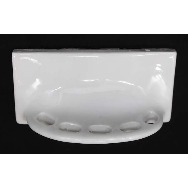 This vintage recessed wall mount toothbrush holder is made of ceramic with a white porcelain finish. It holds five...